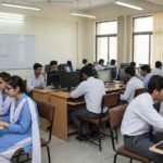 Pakistani college students studying ICS computer subjects in class